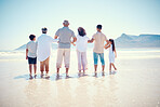 Black family, beach or holding hands with children, parents and grandparents standing in the water from behind. Back, nature or view with kids, senior people and relatives bonding in the ocean