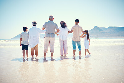 Buy stock photo Black family, beach or holding hands with children, parents and grandparents standing in the water from behind. Back, nature or view with kids, senior people and relatives bonding in the ocean