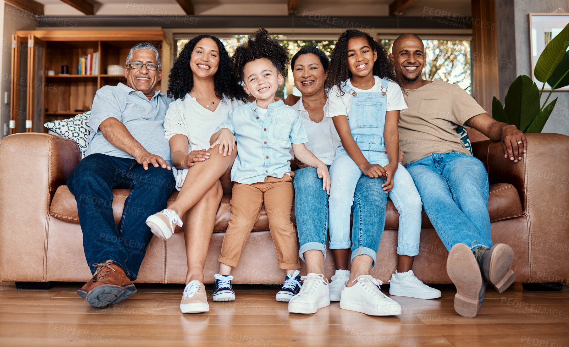 Buy stock photo Black family portrait, living room sofa and bonding of a mother, father and kids on a couch with happiness. Happy, parent love and grandparent support of people laughing in a home together with smile