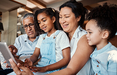 Buy stock photo Family, relax and girl with tablet in home living room for social media, video streaming or web browsing. Technology, smile or care of happy grandfather, grandma and children bonding with touchscreen