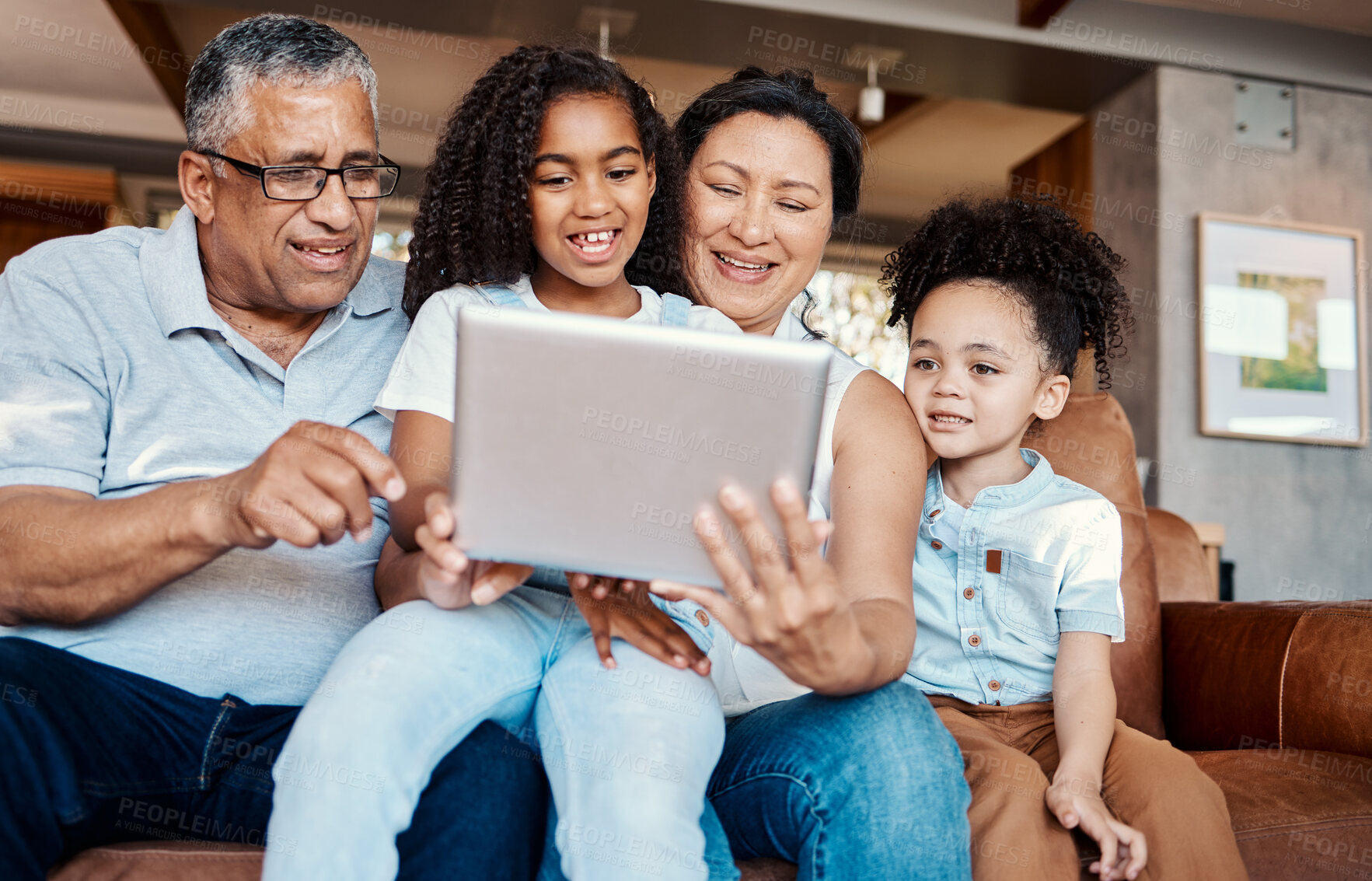 Buy stock photo Family, relax and girl with tablet on sofa in home living room for social media or funny video streaming. Technology, care and happy grandfather, grandma and kids laughing or bonding with touchscreen