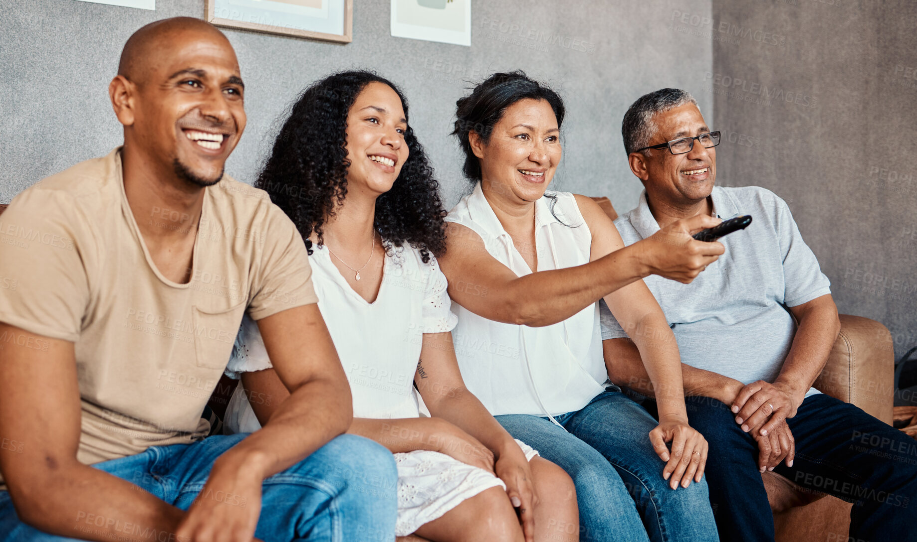 Buy stock photo Movie watching, living room and family together with a smile in a home. Black woman, man and senior people with happiness and tv remote in a house with elderly parents feeling happy from bonding