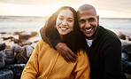 Romantic, happy and portrait of a couple at the beach for a date, bonding or sunset in Bali. Love, hug and young man and woman smiling while relaxing at the ocean for vacation or an anniversary