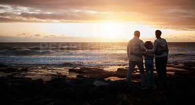 Buy stock photo Family, sunset and mockup with people on the beach looking at the view while bonding in nature. Rear view silhouette of a man, woman and child standing together enjoying the sunrise over the horizon
