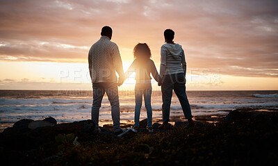 Buy stock photo Sunset, beach and silhouette of parents with child by ocean for bonding, quality time and peace. Happy family, nature and back of mother, father and girl holding hands on vacation, holiday or weekend