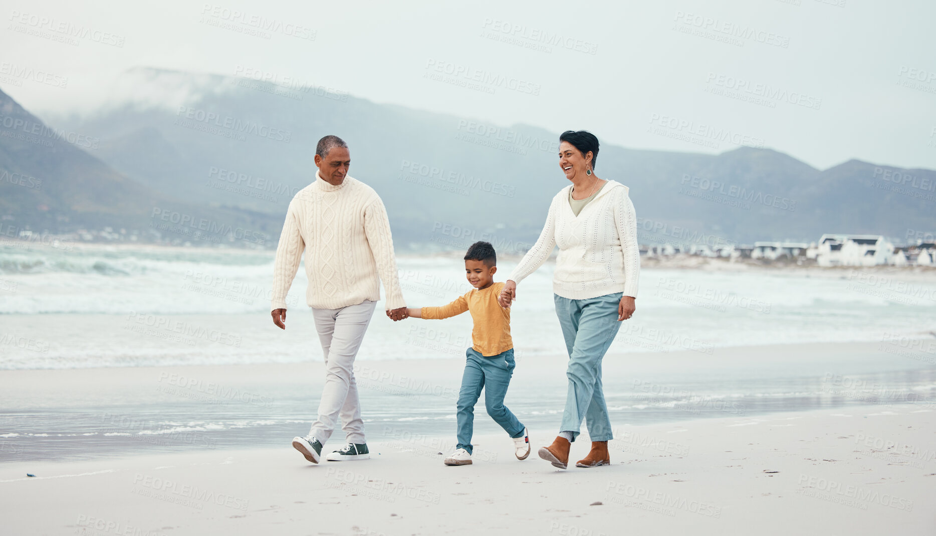 Buy stock photo Grandfather, grandma and child walking on beach enjoying holiday, travel vacation and weekend together. Big family, nature and happy grandparents holding hands for bonding, quality time and relax