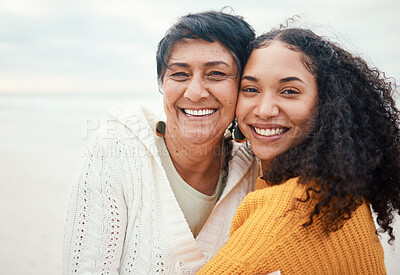 Buy stock photo Happy, hug and portrait of a mother and daughter at the beach for travel, bonding and vacation. Family, smile and elderly mom with an adult woman at the ocean to relax together for happiness