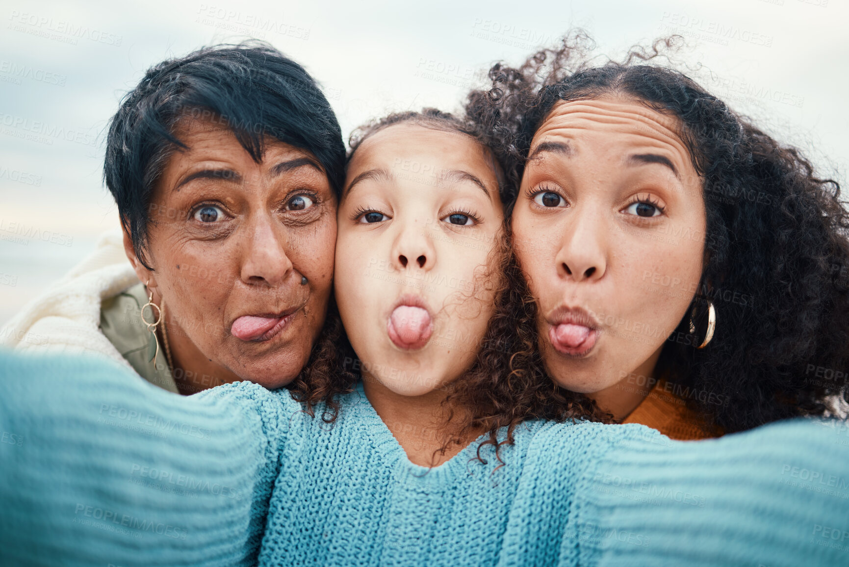 Buy stock photo Funny, tongue out and portrait of a family selfie, silly and goofy at the beach in Bali. Comic, crazy and girl taking a photo with a mother and grandmother for a playful memory on holiday at the sea