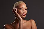 Beauty, makeup and aesthetic, face of black woman in dark studio and platinum hair isolated on grey background. Art, cosmetics and beautiful African model with skincare facial and luxury spa manicure
