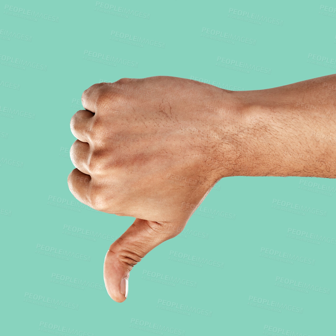 Buy stock photo Hand, thumbs down and negative emoji with a man in the studio on a green background for disagreement. Gesture, no and negativity with a male indoor to disagree, vote or voice his review and feedback