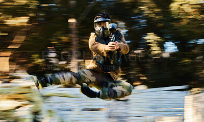 Buy stock photo Action, paintball and man shooting and jumping on battlefield with a gun in a game, match or training. Shooter, blur motion and male with strategy in military aim and shoot target outdoors