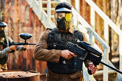 Buy stock photo Portrait, paintball or man with gun in a game or competition for fitness, exercise or cardio workout. Focus, challenge or serious male athlete carrying an army weapon or marker for military training 