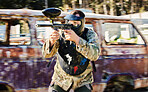 Aim, shooting and paintball man with gun for outdoor battlefield, playground or games in forest adventure training. Target skill of male player or sports person in military focus and survival mission