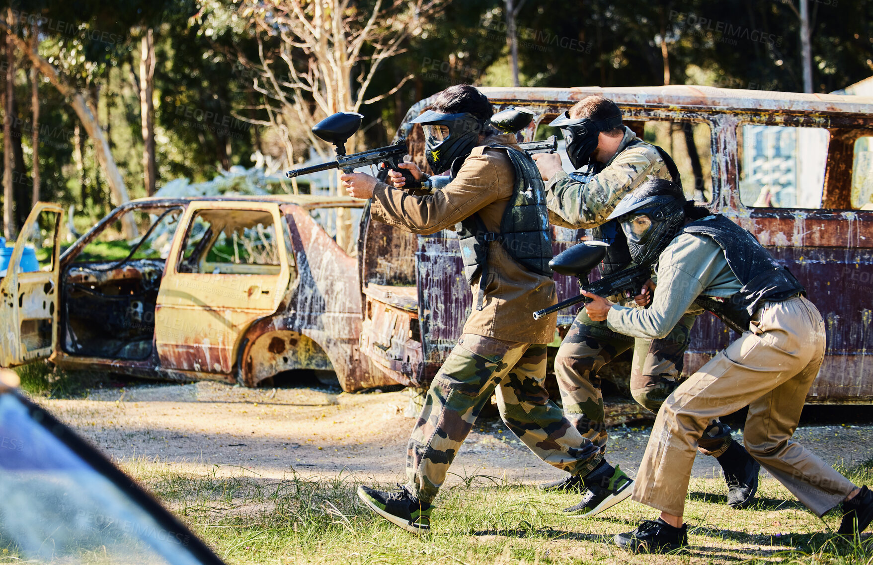 Buy stock photo Team, paintball and army moving on the attack in extreme adrenaline sport, battle or war in the nature outdoors. Group of people soldiers walking or aiming down sights in teamwork sports engagement