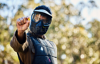 Buy stock photo Man, paintball and hands holding ball on the battlefield for war, shot or engaging act in nature. Male paintballer or soldier showing or pinching paint bullet in military or extreme adrenaline sports