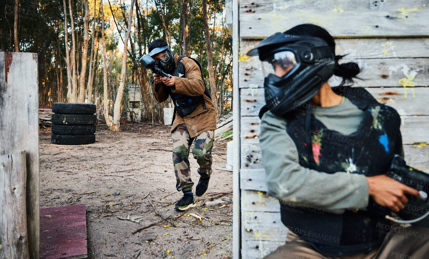 Buy stock photo Paintball, sports and man with gun for battle, game or competition outdoors on field. War fight, military army and male soldier with weapon on shooting range while hiding from opponent for exercise.