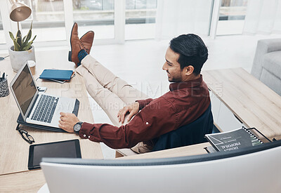 Buy stock photo Working from home man with feet up on desk reading news on laptop with job confidence, productivity and online career. Remote worker, entrepreneur or professional person relax and smiling on computer