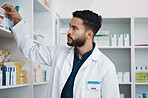 Pharmacy, medical and shelf with man in store for healthcare, drugs dispensary and treatment prescription. Medicine, pills and shopping with pharmacist for check, label information and product