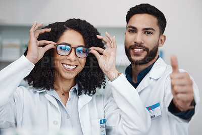 Buy stock photo Pharmacy workers, portrait and thumbs up of pharmacist, healthcare and wellness staff with glasses. Thank you, teamwork and motivation hand sign of medical workers in a clinic or hospital with smile