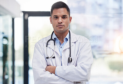 Buy stock photo Portrait, man and doctor with arms crossed, focused and confident in hospital, clinic and surgery. Serious, proud and young medical worker in lab coat for healthcare services, wellness and commitment