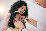 Optometry, healthcare and optometrist with glasses for a child for eye care, vision or wellness. Optic health, ophthalmology and optician helping a girl kid with prescription spectacles in a clinic.