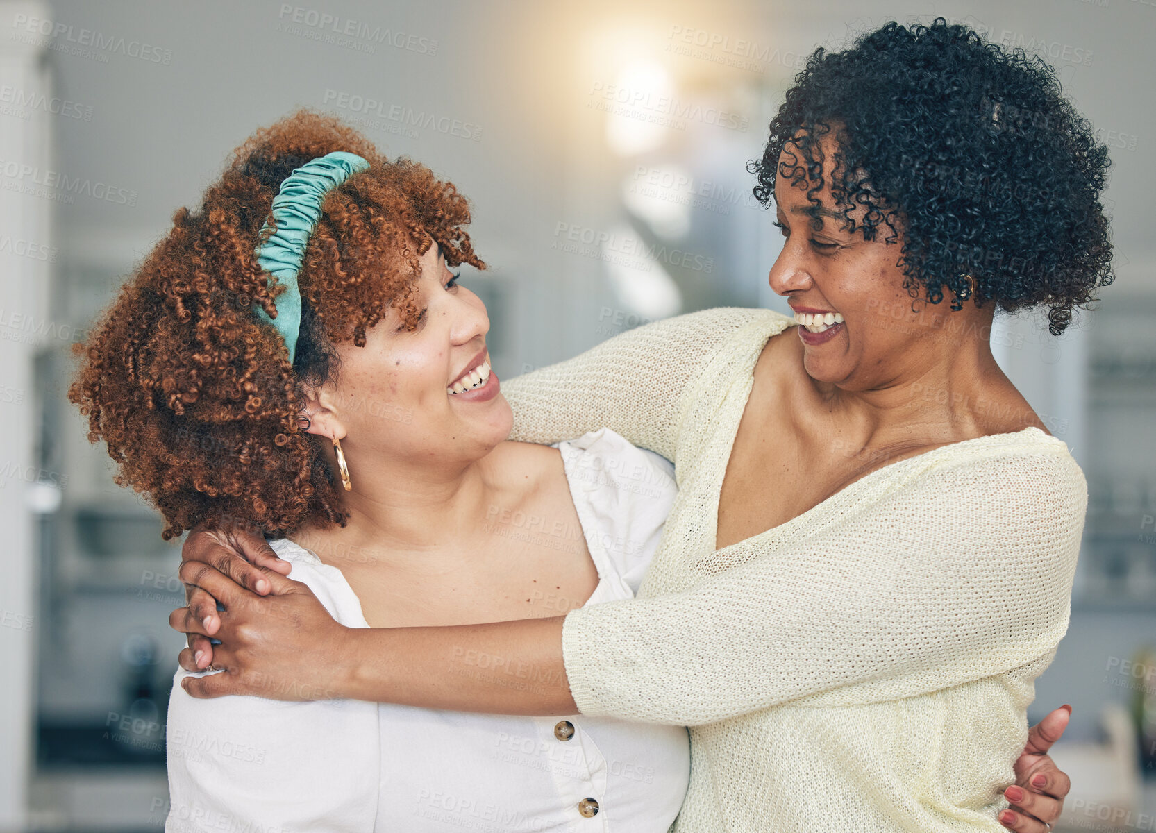 Buy stock photo Hug, happy and a mother and daughter with admiration, love and laughing in the living room. Smile, affection and an African mom and woman hugging on mothers day during a visit or reunion together