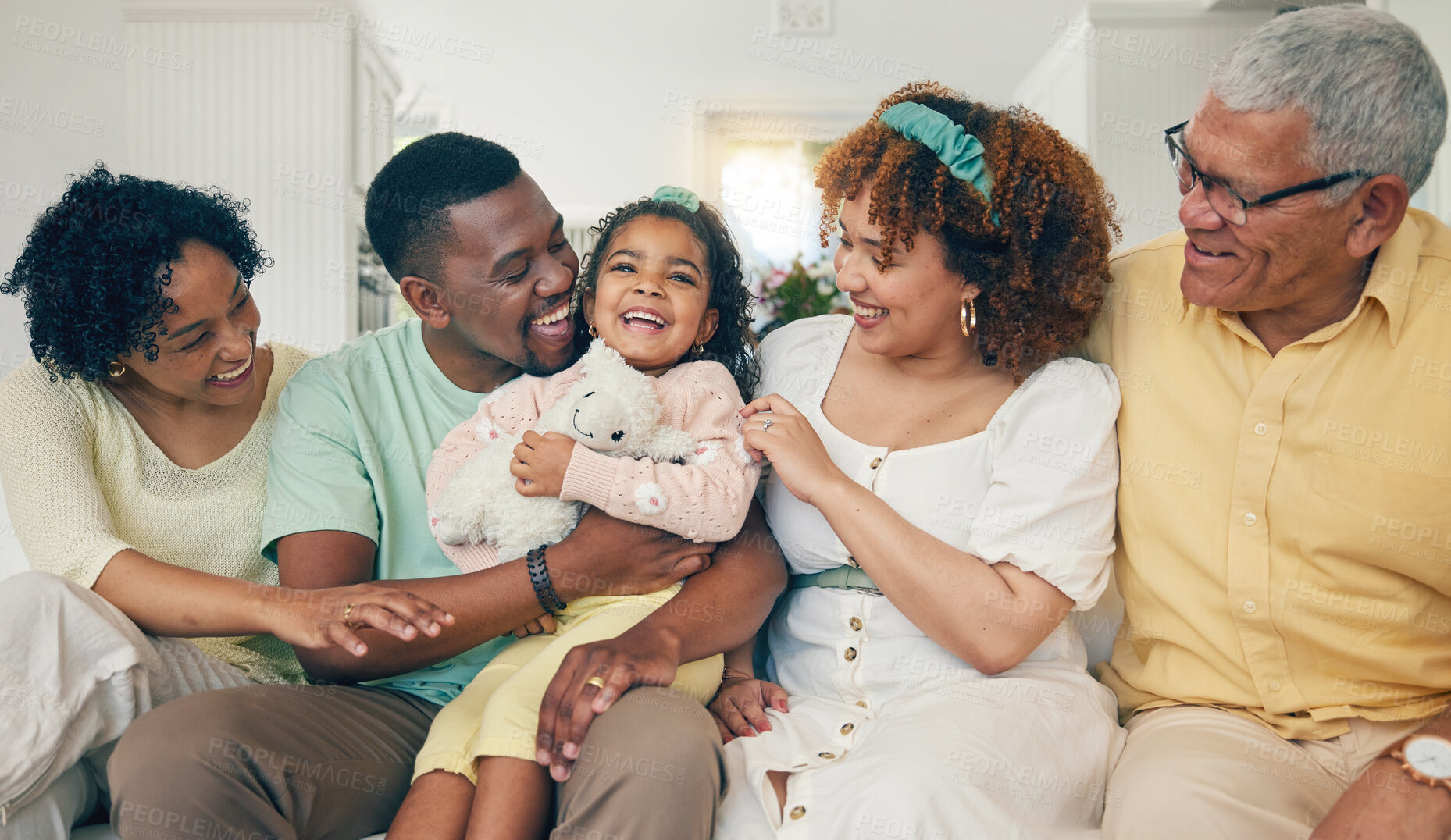 Buy stock photo Black family, laugh and living room couch with bonding, parent love and care in home. Lounge, happiness and children with mom and dad together feeling happy with a hug on a sofa with mama and dad