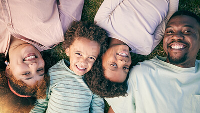 Buy stock photo Smile, black family lying on grass from above and happy face of mom, dad and children together. Weekend, relax and people in garden, top view of woman, man and kids with happiness and love in Africa.