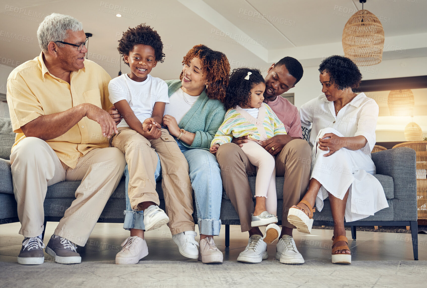 Buy stock photo Love, relax and black family on couch, quality time and conversation for bonding, weekend break and smile. Grandparents, mother and father with kids, siblings or children on sofa, happiness or loving