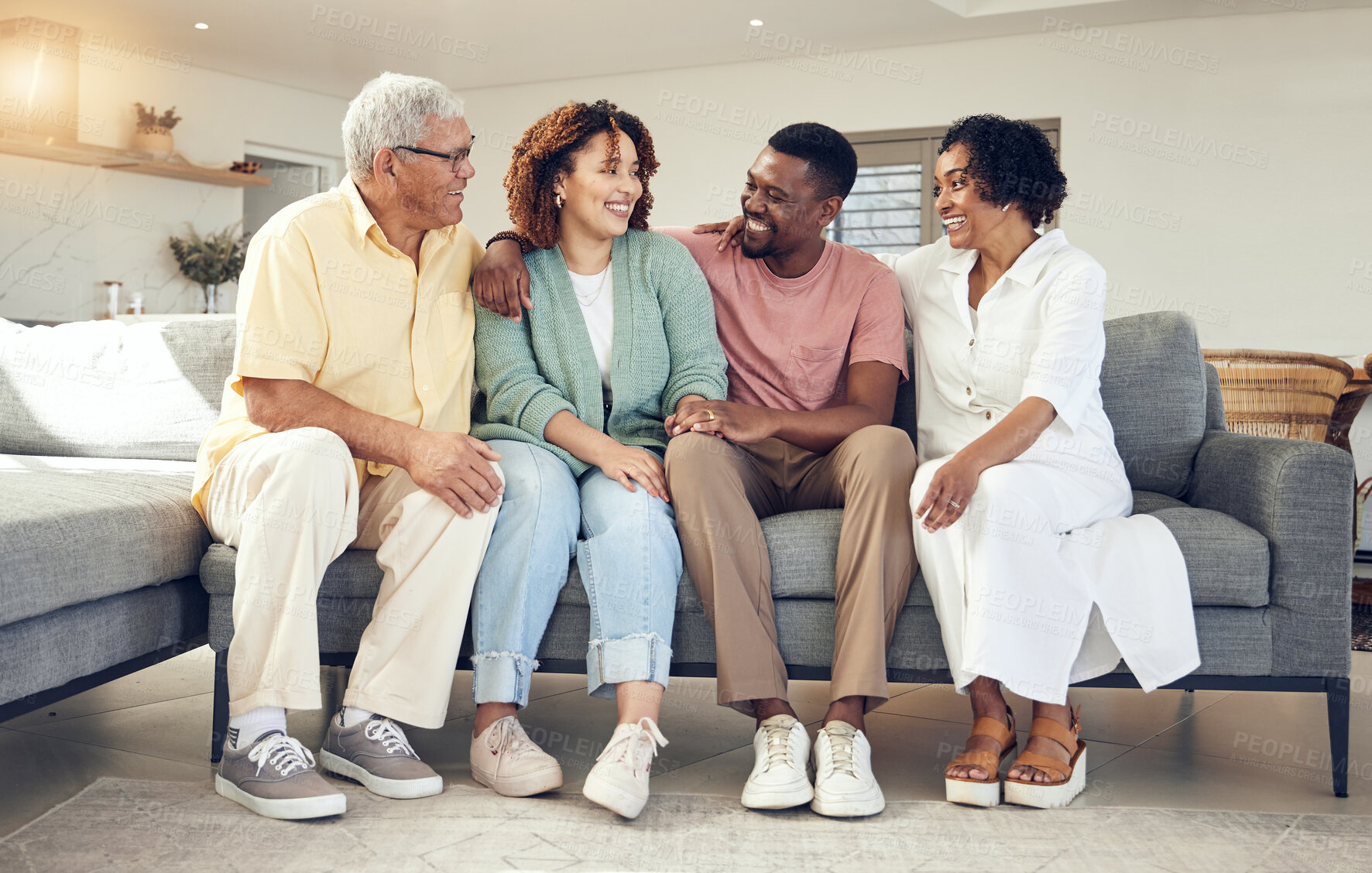 Buy stock photo Happy family, parents and couple relax on a sofa, talking and laughing while bonding in a living room. Woman, man and seniors on a couch, happy and smile while enjoying weekend and retirement at home