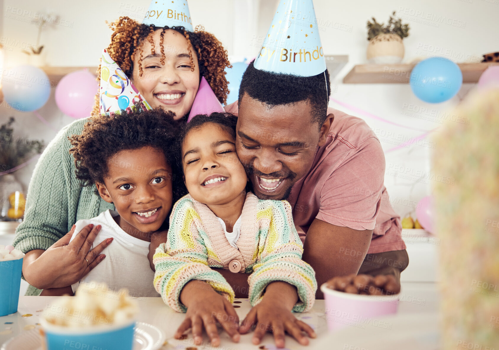 Buy stock photo Birthday, party and hug with family in kitchen for celebration, bonding and affectionate. Happiness, excited and care with parents and children at home for surprise, fun and special event 