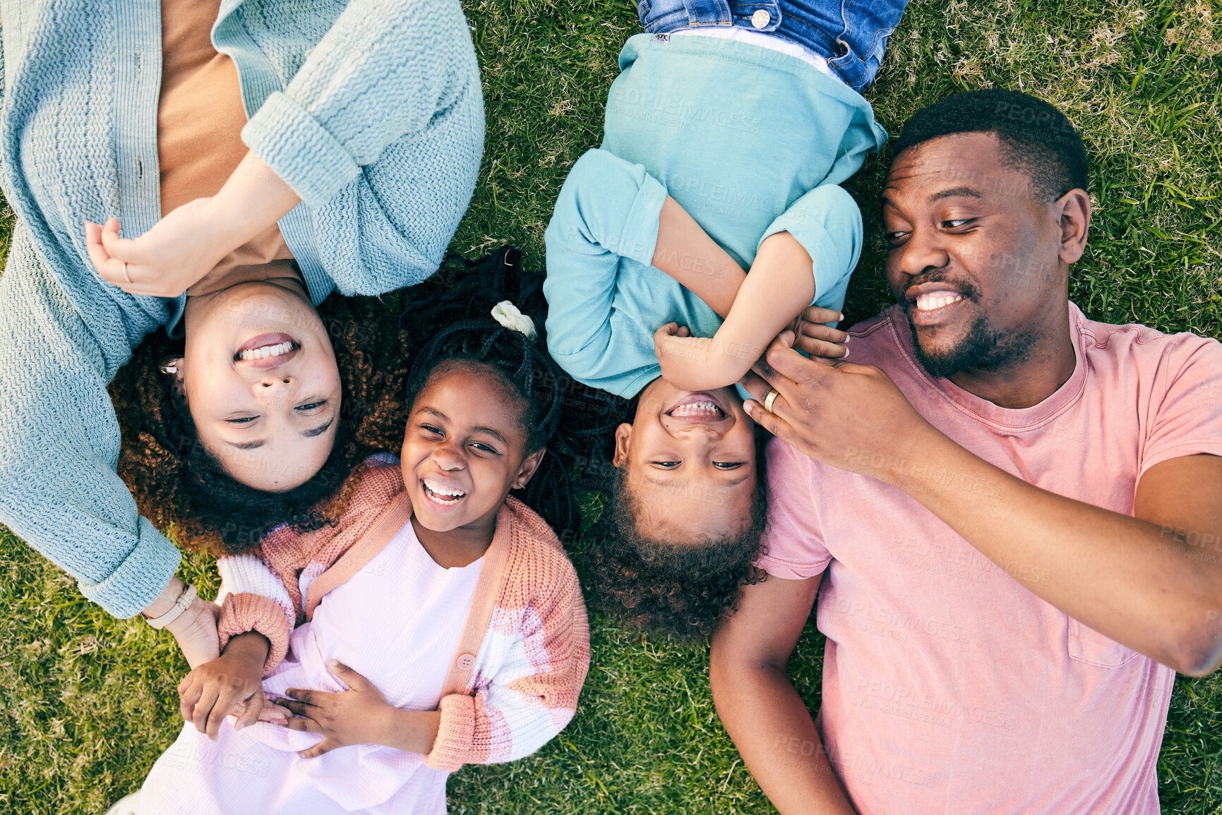 Buy stock photo Top view, black family and parents with kids on grass, carefree and happiness on vacation, relax and smile. Mother, father and children in park, freedom and playful together, love and bonding outdoor