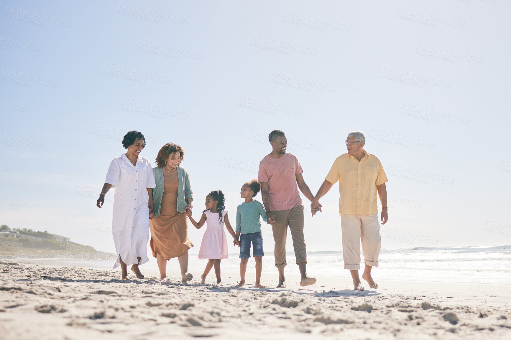 Buy stock photo Grandparents, parents and children walking on beach holding hands for love, support and quality time together. Travel, happy and kids with big family by ocean for holiday, summer vacation and weekend