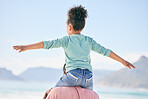 Beach, black man with child on shoulders from back on playful family holiday in Australia with freedom and fun. Travel, fun and happy father and girl playing, flying and bonding together on vacation.