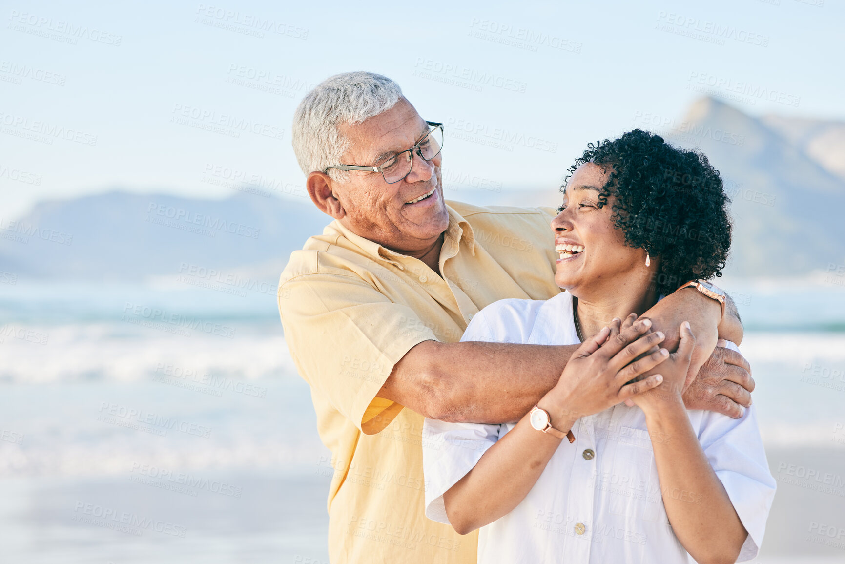 Buy stock photo Senior couple at beach, hug and happy with travel, retirement and love outdoor, vacation with view and relax in nature. Peace, zen and tropical island, man and woman with marriage and happiness