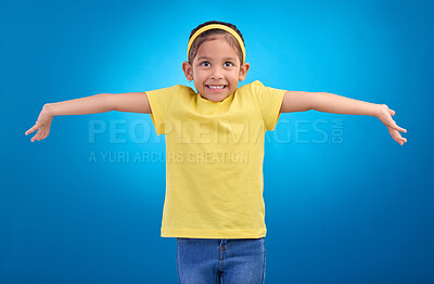 Buy stock photo Girl, child and happy or shrugging or unsure in studio with arms and hands stretched with a smile. Kid on blue background clueless, doubt and confused about question or reaction with hand gesture