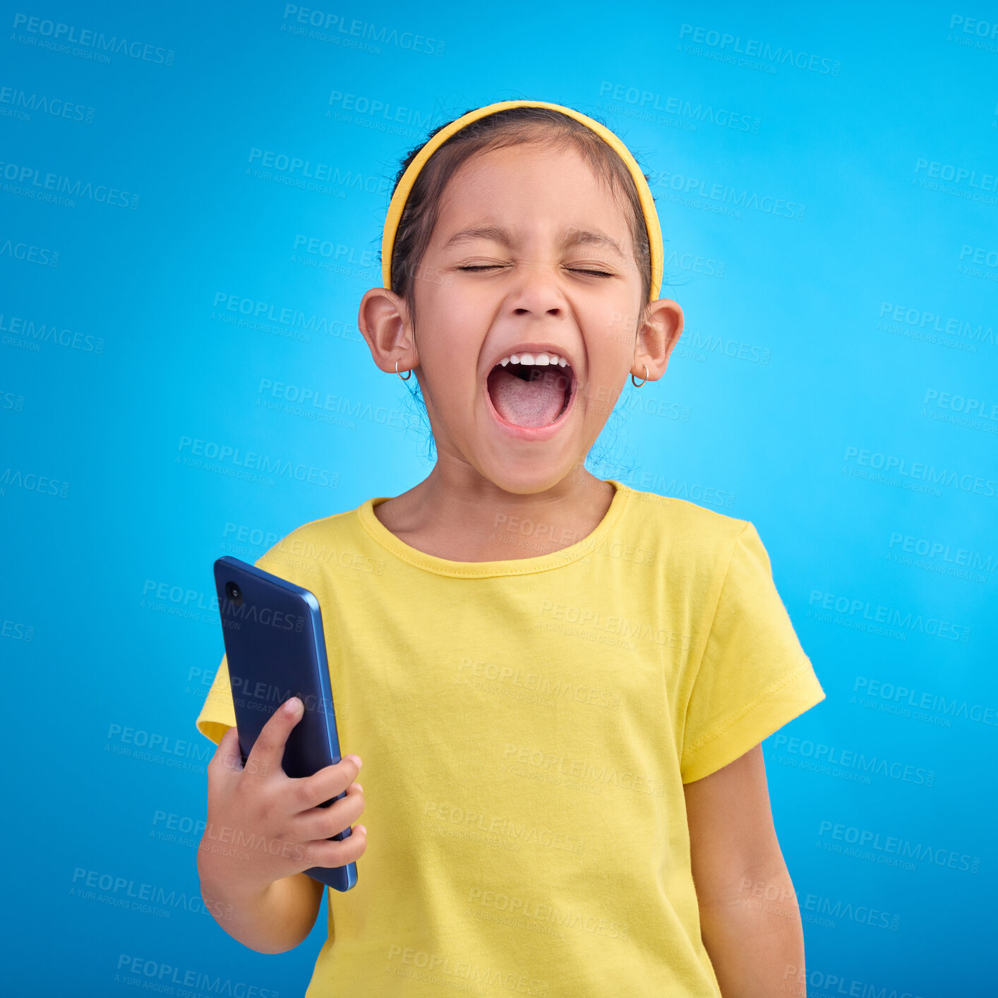 Buy stock photo Phone, scream and child on blue background with attitude, upset and lose online game, network or internet. Technology, bad behaviour and face of girl upset, angry and shout with smartphone in studio