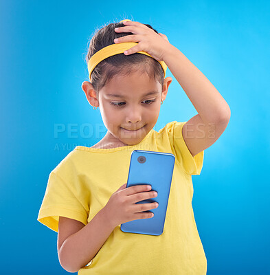 Buy stock photo Phone, stress and child worry on blue background with mistake, accident and guilty expression in studio. Technology, smartphone and young girl with anxiety, stressed out and worried for trouble