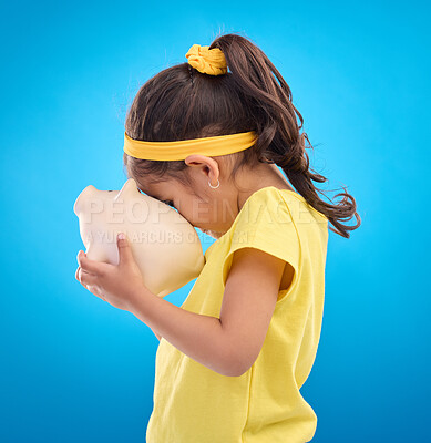 Buy stock photo Child, holding and piggy bank in studio for finance, planning and future investment against blue background. Money, box and girl with financial, savings and growth, invest and management learning