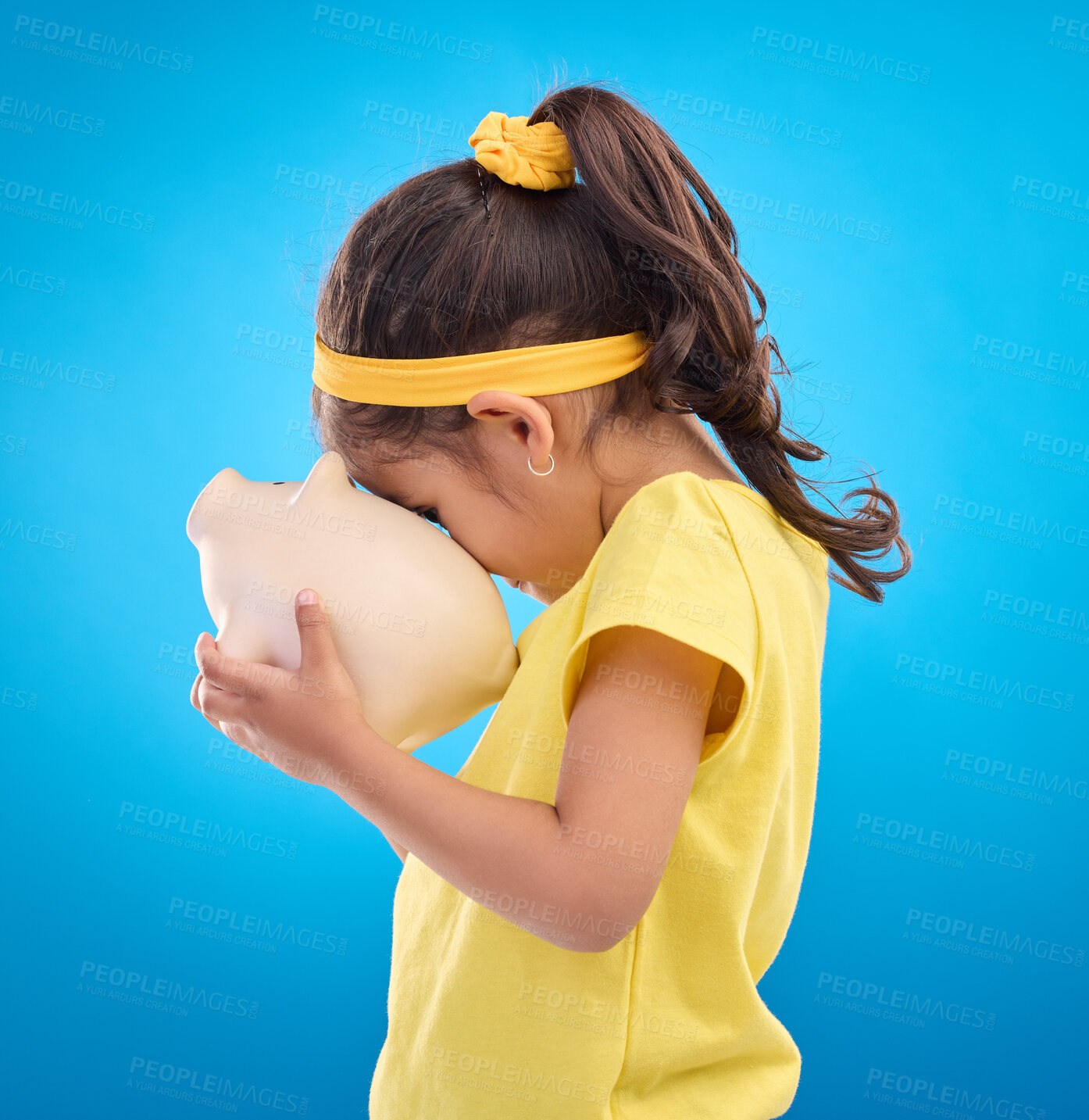 Buy stock photo Child, holding and piggy bank in studio for finance, planning and future investment against blue background. Money, box and girl with financial, savings and growth, invest and management learning