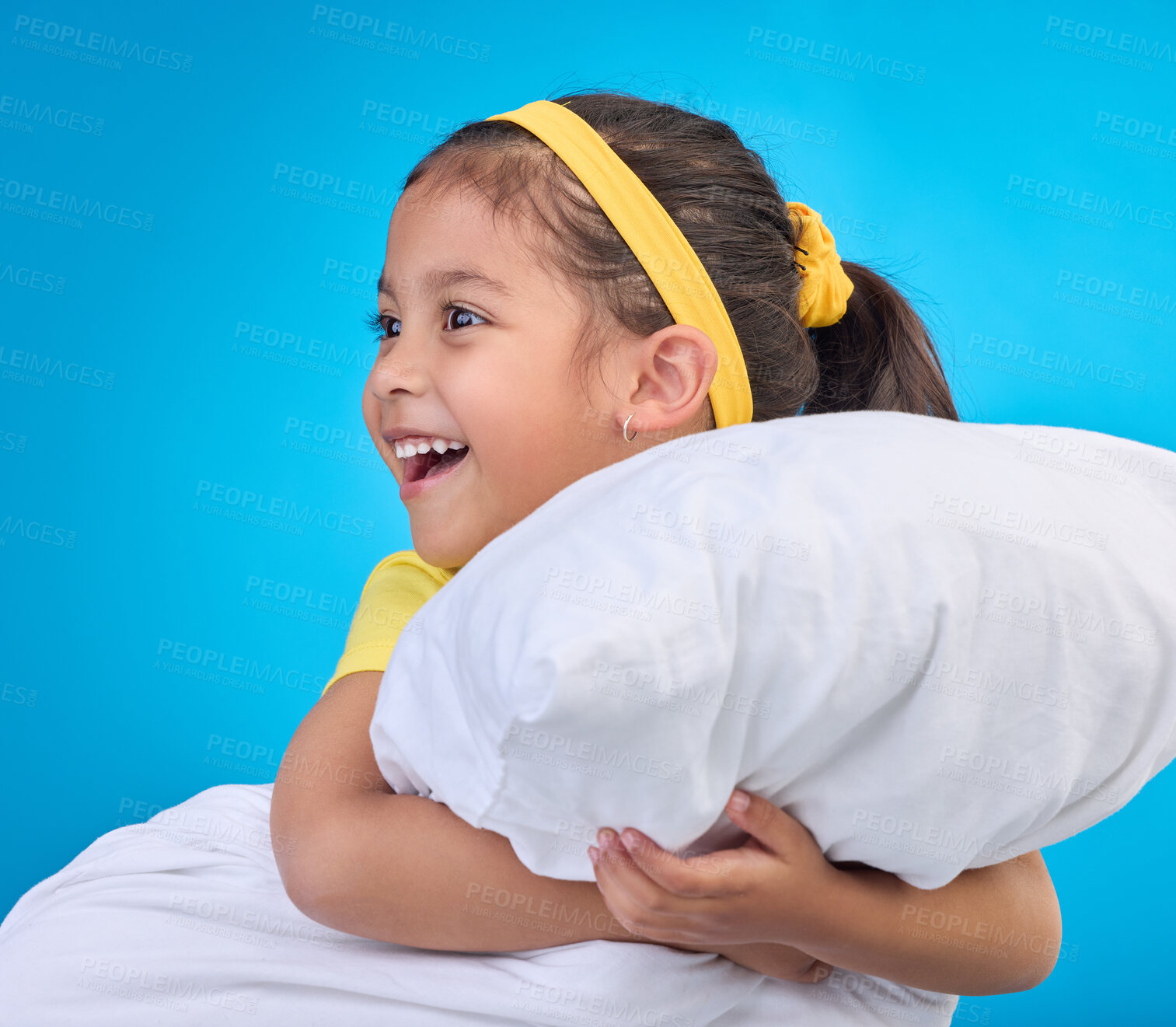 Buy stock photo Happy, cute and child with a pillow for sleep isolated on a blue background in a studio. Smile, excited and a young little girl thinking of sleeping, getting ready for a nap or rest on a backdrop