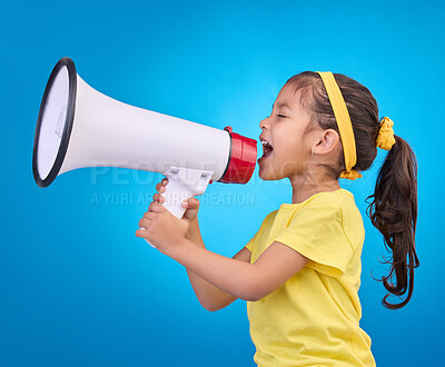 Buy stock photo Communication, shout and child with megaphone for news, opinion and announcement on blue background. Talking, speaking mockup and young girl with loudspeaker for voice, scream and attention in studio