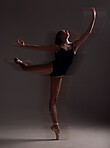 Flexibility, dance and woman in the dark for ballet isolated on a black background in a studio. Creative, elegant and dancer dancing for a theater performance, rehearsal or ballerina movement