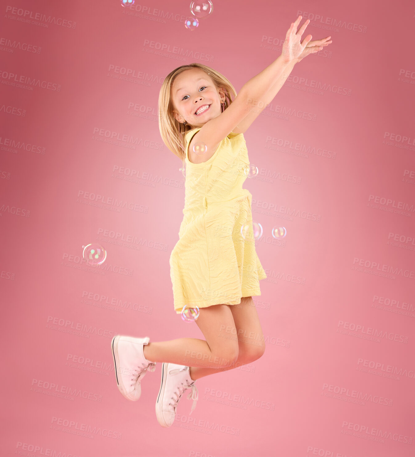 Buy stock photo Child, jump and bubbles for a smile portrait in studio with a pink background for fun. Female kid model jumping with happiness, play and cheerful face isolated on gradient color and space