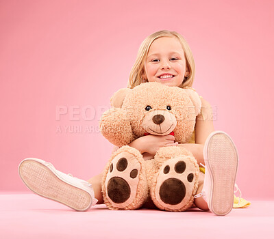 Buy stock photo Teddy bear love, girl and portrait with a soft toy with happiness and care for toys in a studio. Isolated, pink background and a young female child feeling happy, joy and cheerful with stuffed friend
