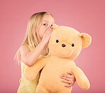 Teddy, secret and young girl talking and whispering to a toy bear in a studio. Playing, child and bonding with love and care for toys with isolated pink background in a happy discussion together
