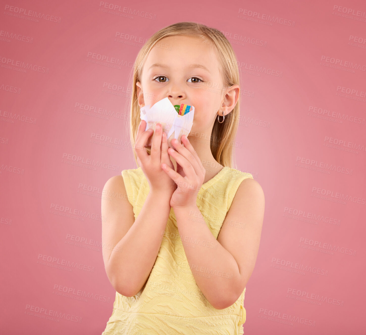 Buy stock photo Girl child, cupcake and portrait in studio on a pink background while eating cake. Face of a female kid model with a sweet snack, creativity and paper in hand isolated on color and a gradient space