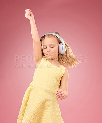 Buy stock photo Music headphones, dance and girl kids in studio, pink background or color backdrop for happiness. Happy children, dancing and listening to radio, audio and sound with energy, fun songs and freedom 