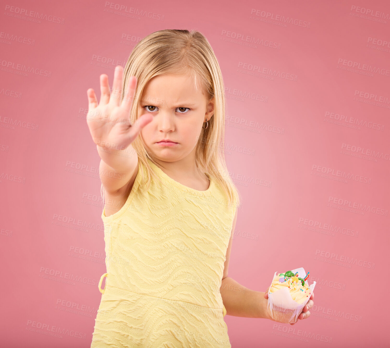 Buy stock photo Stop, angry and child portrait with a no hand gesture and cupcake showing a sharing problem. Conflict, frustrated and serious little girl with a birthday dessert in isolated pink background in studio