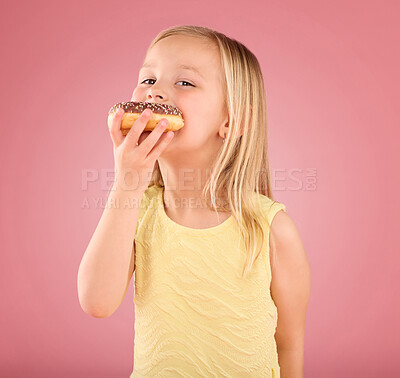 Buy stock photo Portrait, girl kid and donuts on pink background, studio and color backdrop for dessert, sweet round treat and sugar. Happy young child eating doughnut, baked snack and delicious pastry of junk food